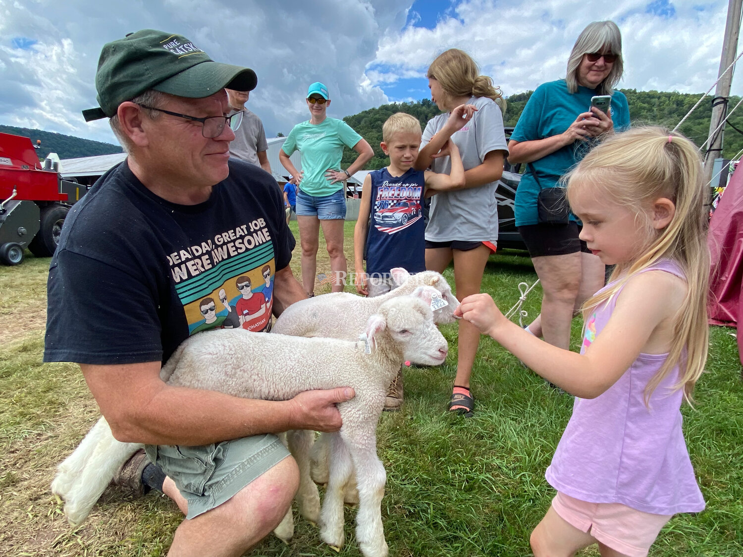 Chloe Anderson, 3, Delhi, meets Hansel and Gretel, two horned Dorset lambs exhibited at the Delaware County Fair by Don Conklin of SaJoBe Farm in Walton.
